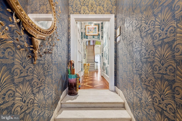 staircase featuring dark parquet floors