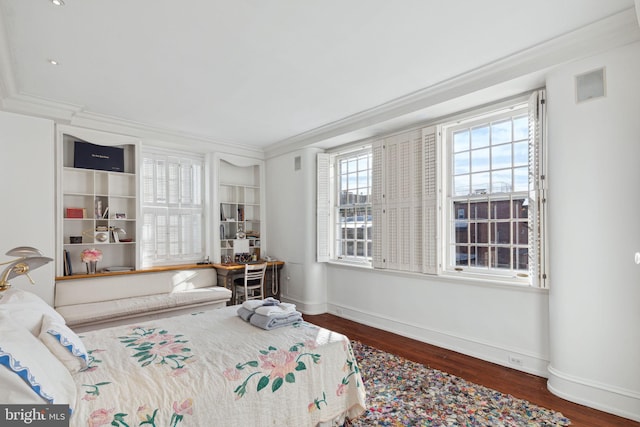 bedroom featuring crown molding and dark hardwood / wood-style flooring