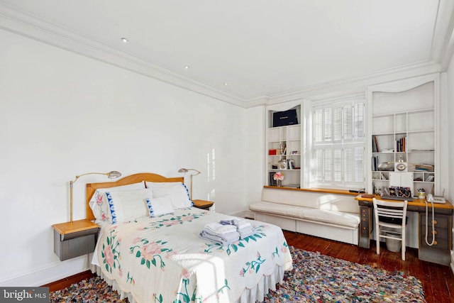 bedroom featuring crown molding and dark hardwood / wood-style floors