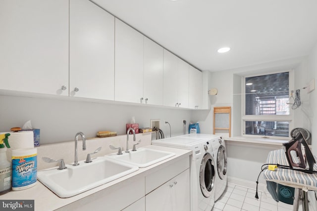 laundry room featuring washer hookup, cabinets, washing machine and clothes dryer, and sink