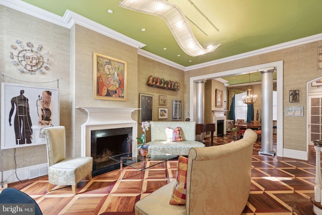 living room featuring crown molding, decorative columns, a notable chandelier, and parquet flooring