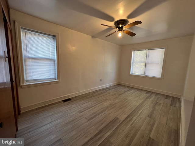 empty room featuring ceiling fan and hardwood / wood-style flooring