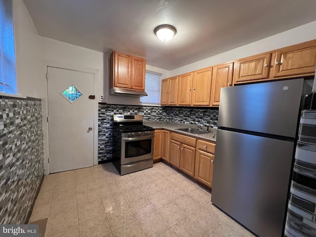 kitchen featuring backsplash, stainless steel appliances, light tile floors, and sink