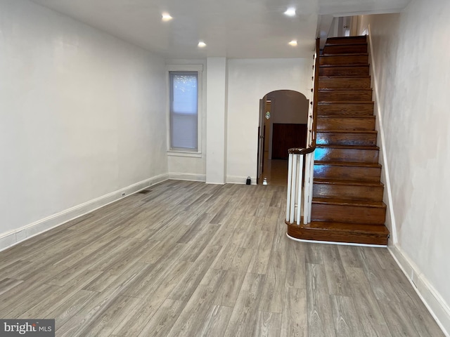 stairway featuring light wood-type flooring