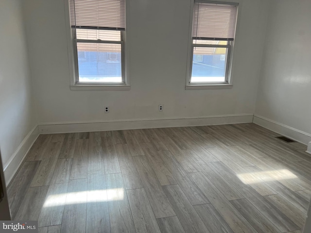 empty room featuring light hardwood / wood-style floors and a healthy amount of sunlight