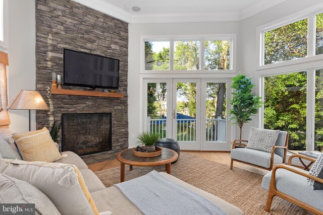 164 W Lake Dr, Annapolis, MD 21403 - living room with plenty of natural light, ornamental molding, light wood-type flooring, and a fireplace