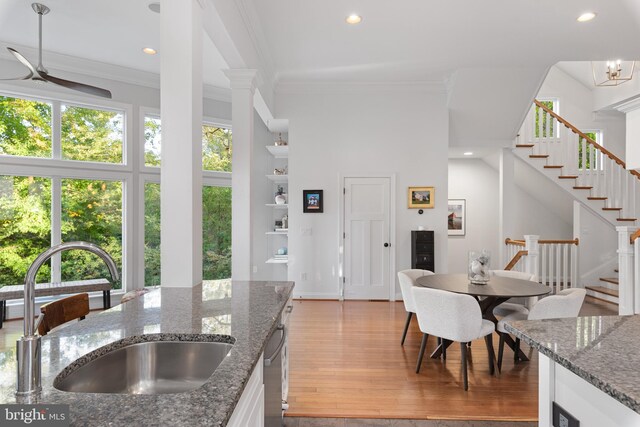 164 W Lake Dr, Annapolis, MD 21403 - kitchen with light hardwood / wood-style flooring, dark stone counters, white cabinets, and ceiling fan with notable chandelier