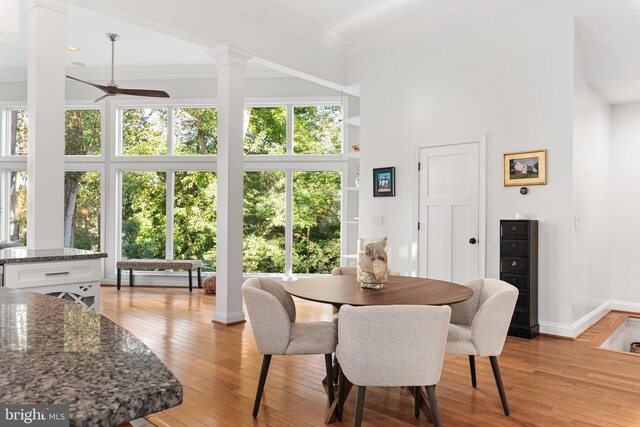 164 W Lake Dr, Annapolis, MD 21403 - dining area featuring a high ceiling, ceiling fan, decorative columns, and light hardwood / wood-style flooring