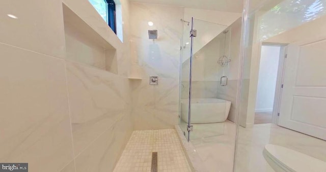 bathroom with a shower with shower door, tile walls, toilet, and tile floors