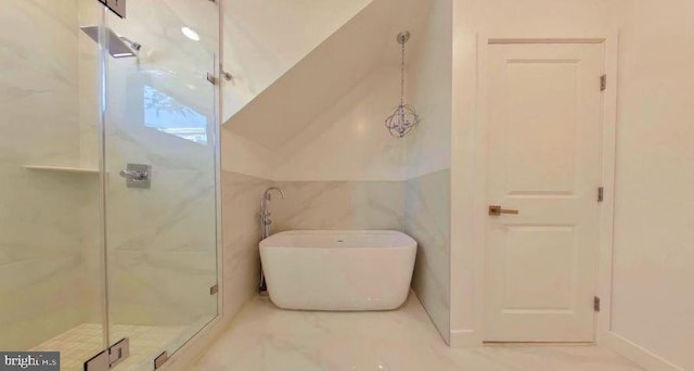 bathroom featuring plus walk in shower, tile flooring, and tile walls