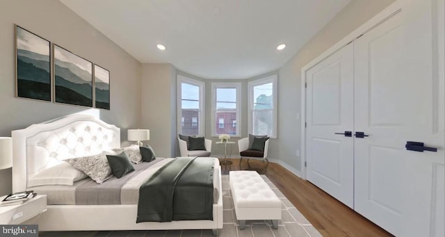 bedroom with a closet and hardwood / wood-style flooring