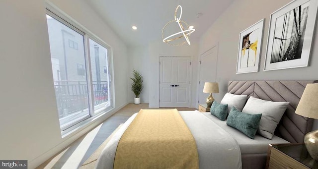 carpeted bedroom featuring an inviting chandelier