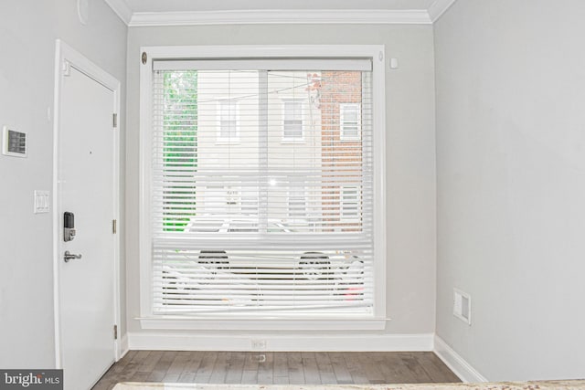 interior space with dark hardwood / wood-style floors and ornamental molding