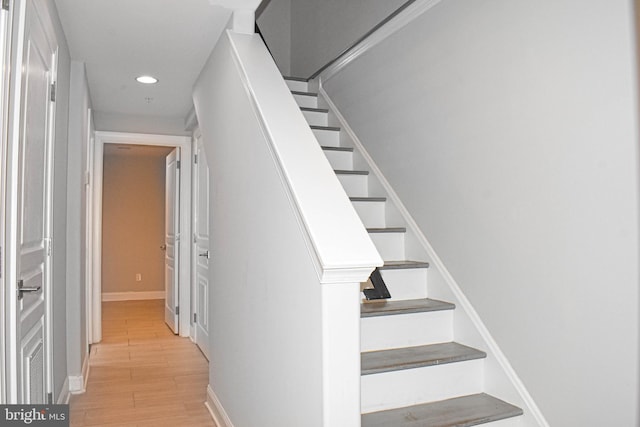 stairs with light hardwood / wood-style flooring