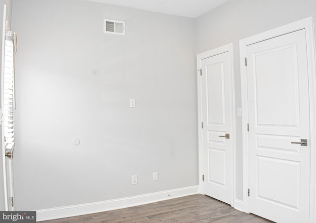 unfurnished room featuring dark wood-type flooring