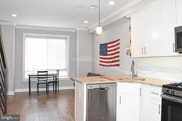 kitchen with hanging light fixtures, backsplash, dark hardwood / wood-style floors, appliances with stainless steel finishes, and light stone counters