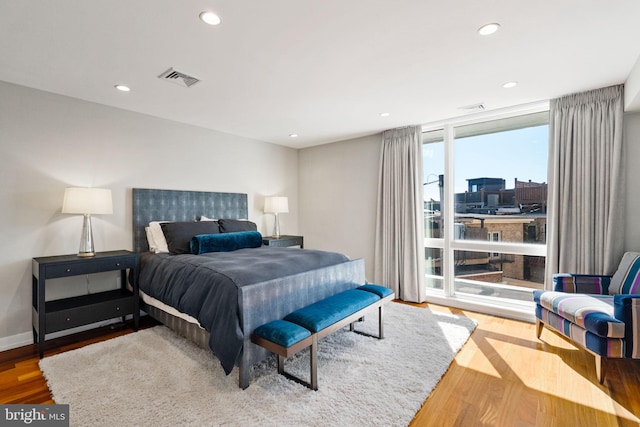 bedroom featuring multiple windows and light wood-type flooring