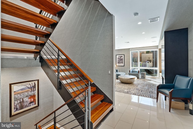 stairs featuring light tile floors