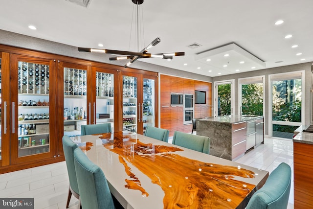 dining area featuring french doors and light tile floors