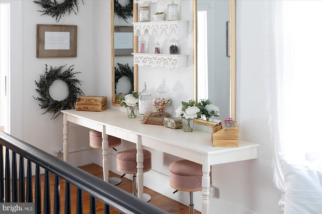 bar with hardwood / wood-style floors