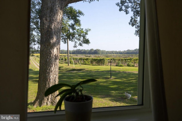 interior space with a yard and a rural view