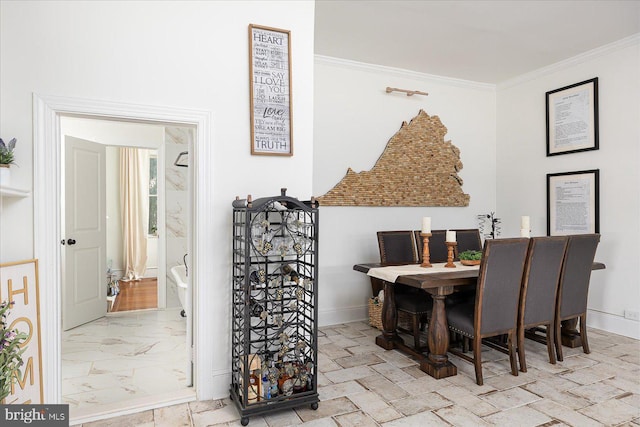 dining space featuring crown molding