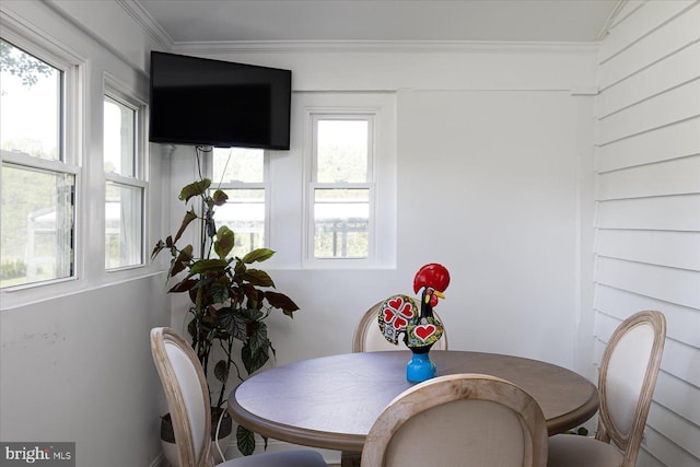 dining room featuring a healthy amount of sunlight and ornamental molding