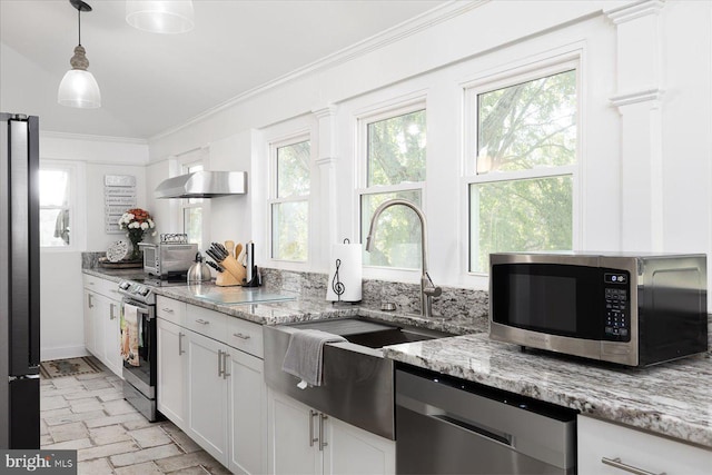 kitchen with white cabinets, sink, light stone counters, stainless steel appliances, and extractor fan