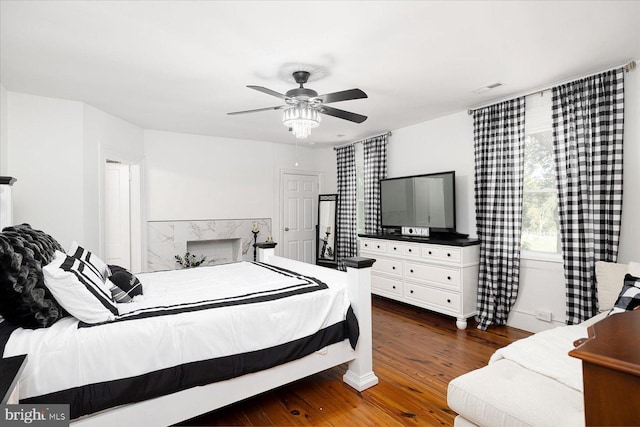 bedroom with ceiling fan and dark hardwood / wood-style floors