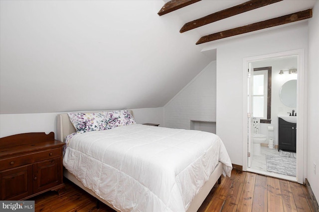 bedroom with sink, lofted ceiling, dark wood-type flooring, and ensuite bath