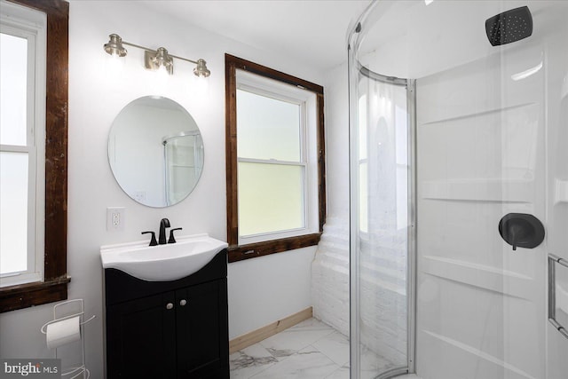 bathroom featuring vanity, walk in shower, and a wealth of natural light