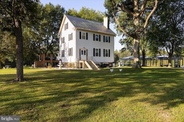 back of house with a lawn