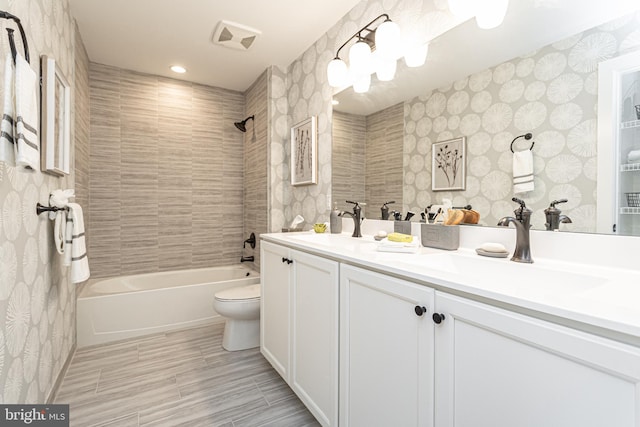 full bathroom with tiled shower / bath combo, tile flooring, toilet, and double vanity