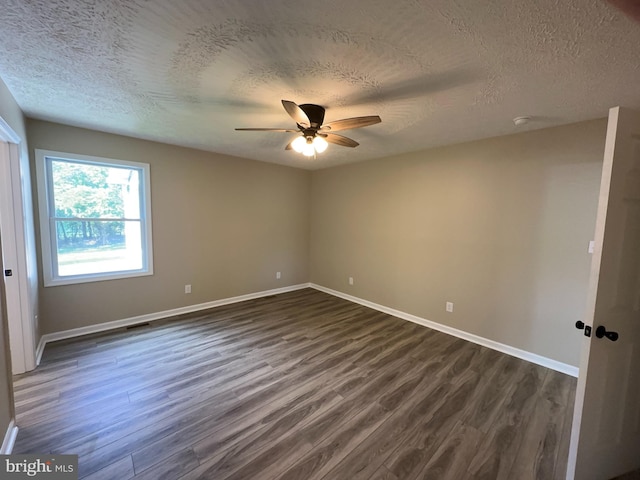 empty room with a textured ceiling, ceiling fan, and dark wood-type flooring