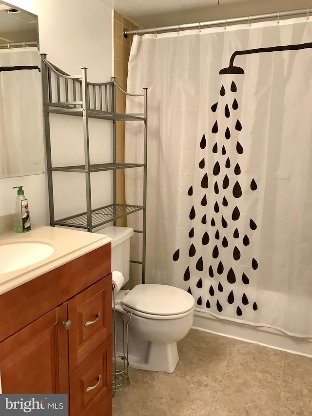 bathroom featuring tile floors, toilet, and vanity