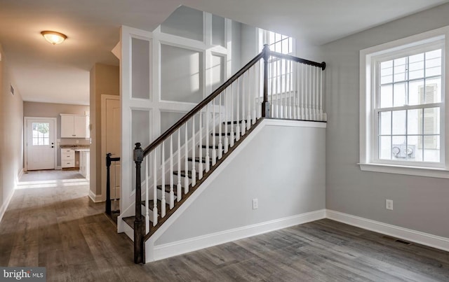 stairs featuring hardwood / wood-style flooring