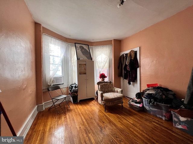 living area with hardwood / wood-style floors and cooling unit