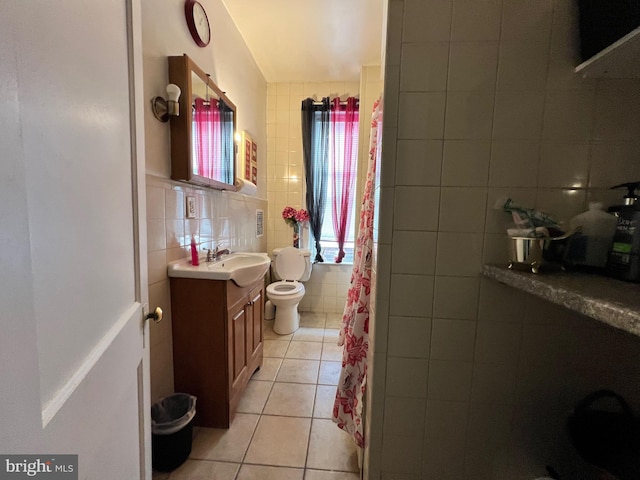 bathroom featuring vanity, backsplash, tile patterned floors, toilet, and tile walls