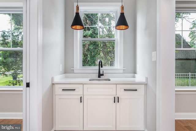 bar featuring plenty of natural light and sink