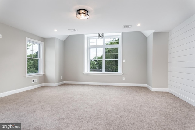 spare room featuring light carpet