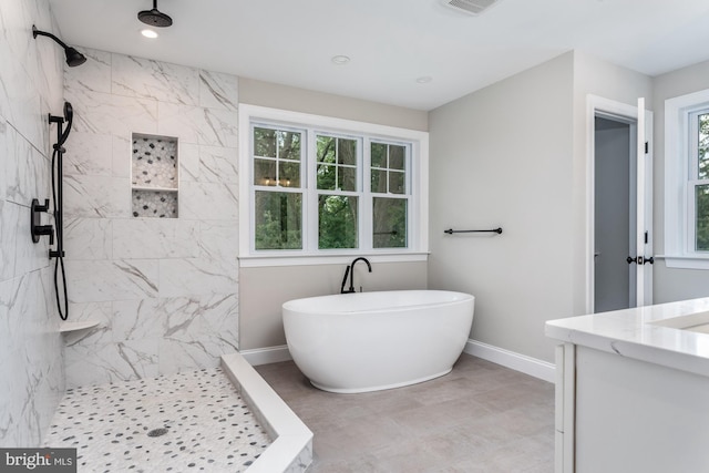 bathroom with vanity and separate shower and tub