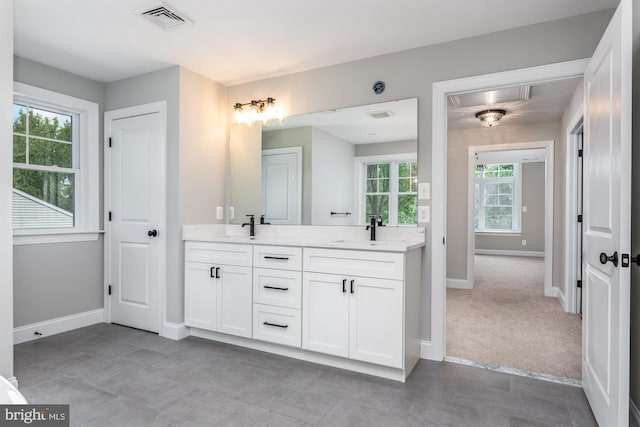 bathroom with vanity and a wealth of natural light