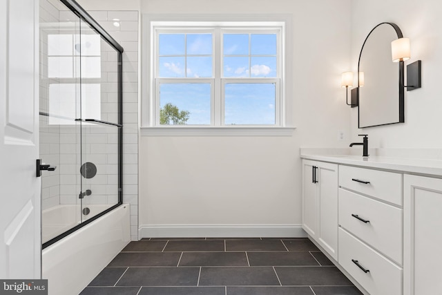 bathroom with tile patterned floors, vanity, and combined bath / shower with glass door