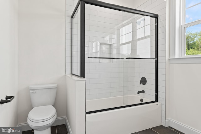 bathroom with toilet, tile patterned floors, and enclosed tub / shower combo