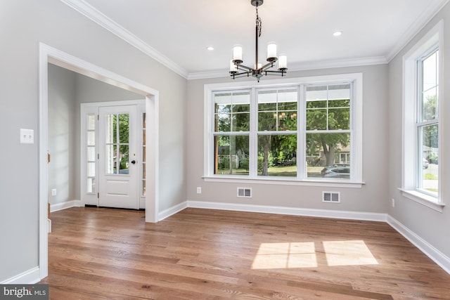 interior space with hardwood / wood-style flooring, a notable chandelier, and a healthy amount of sunlight