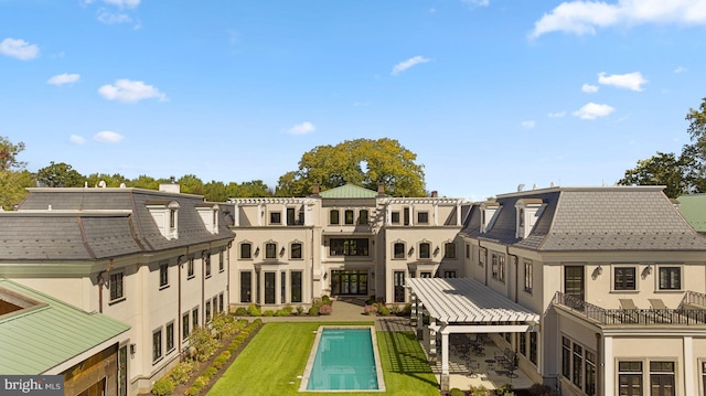 back of property featuring a patio and a lawn