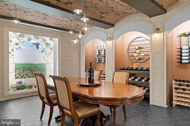 dining space featuring brick ceiling and tile walls