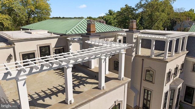 view of front of property with a pergola and a balcony