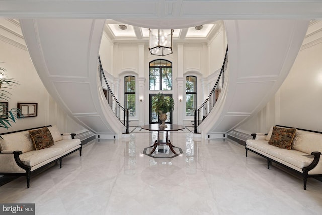 entrance foyer with a notable chandelier and crown molding