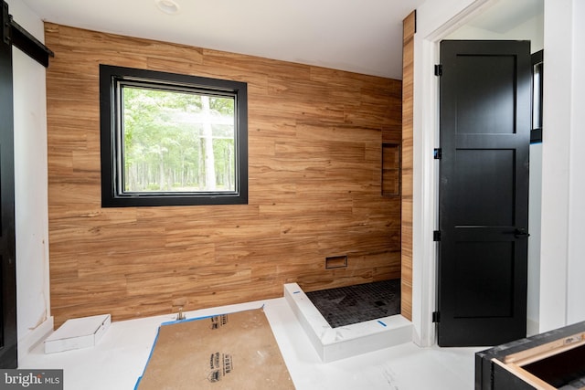 bathroom featuring wooden walls